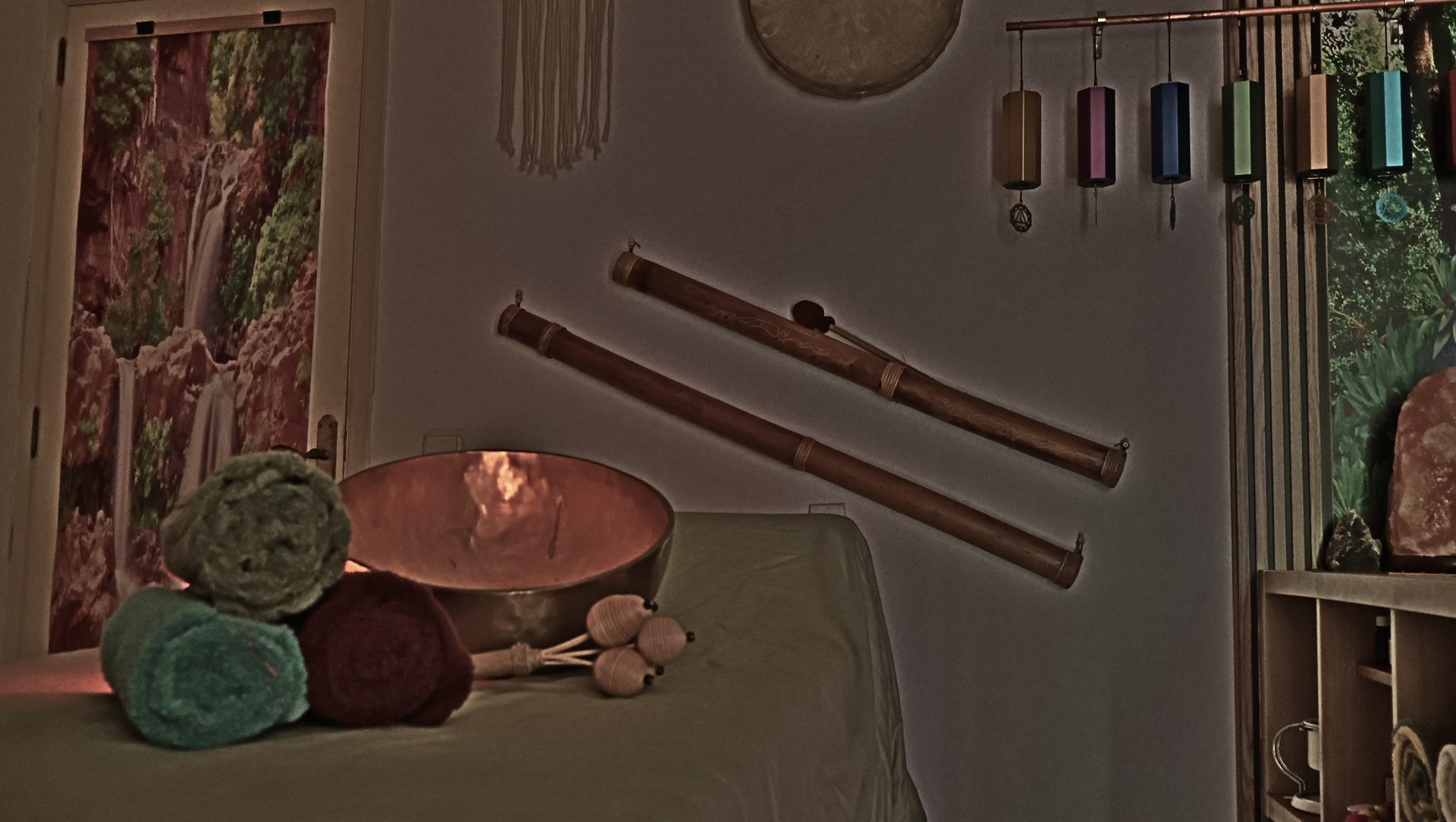 A gong, singing bowls and Koshi bells laid out for a relaxation massage with sound