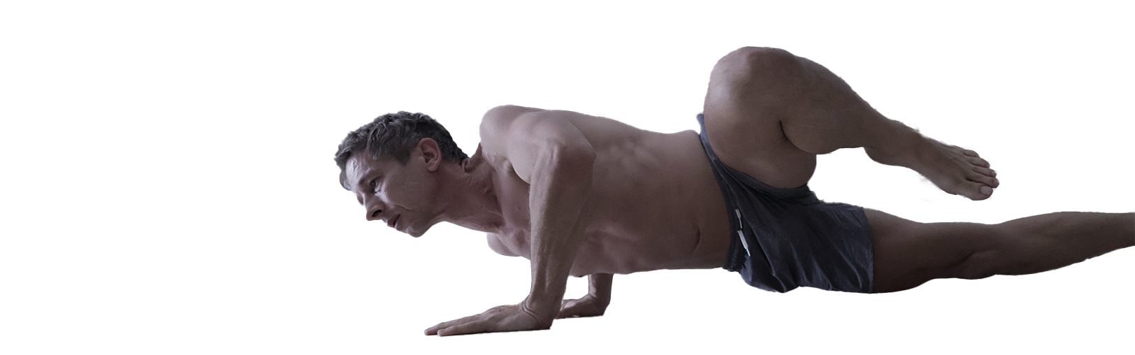 A press-up held mid-movement, strength work on the floor